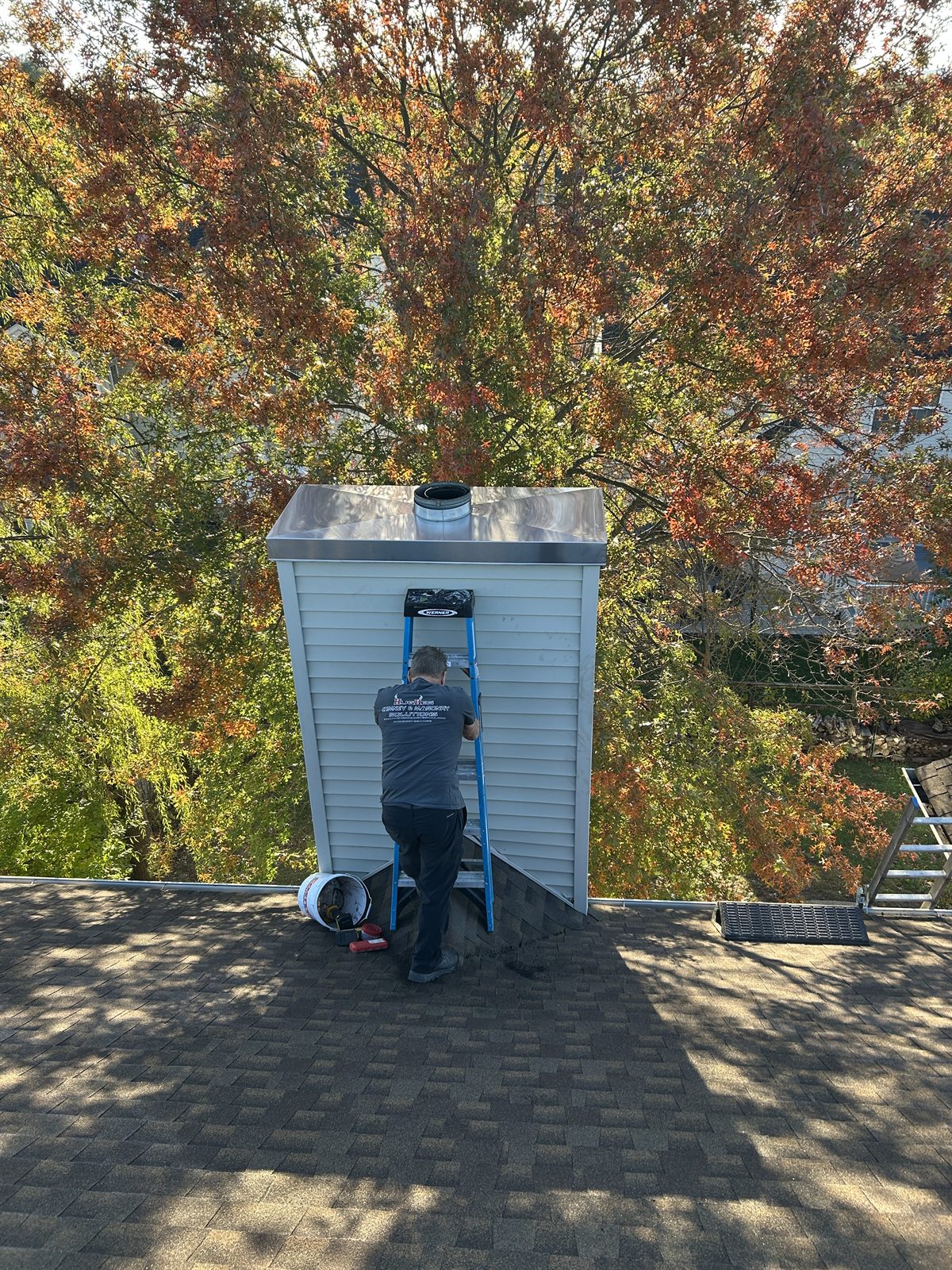 Hughes technician installing a new chimney chase cover