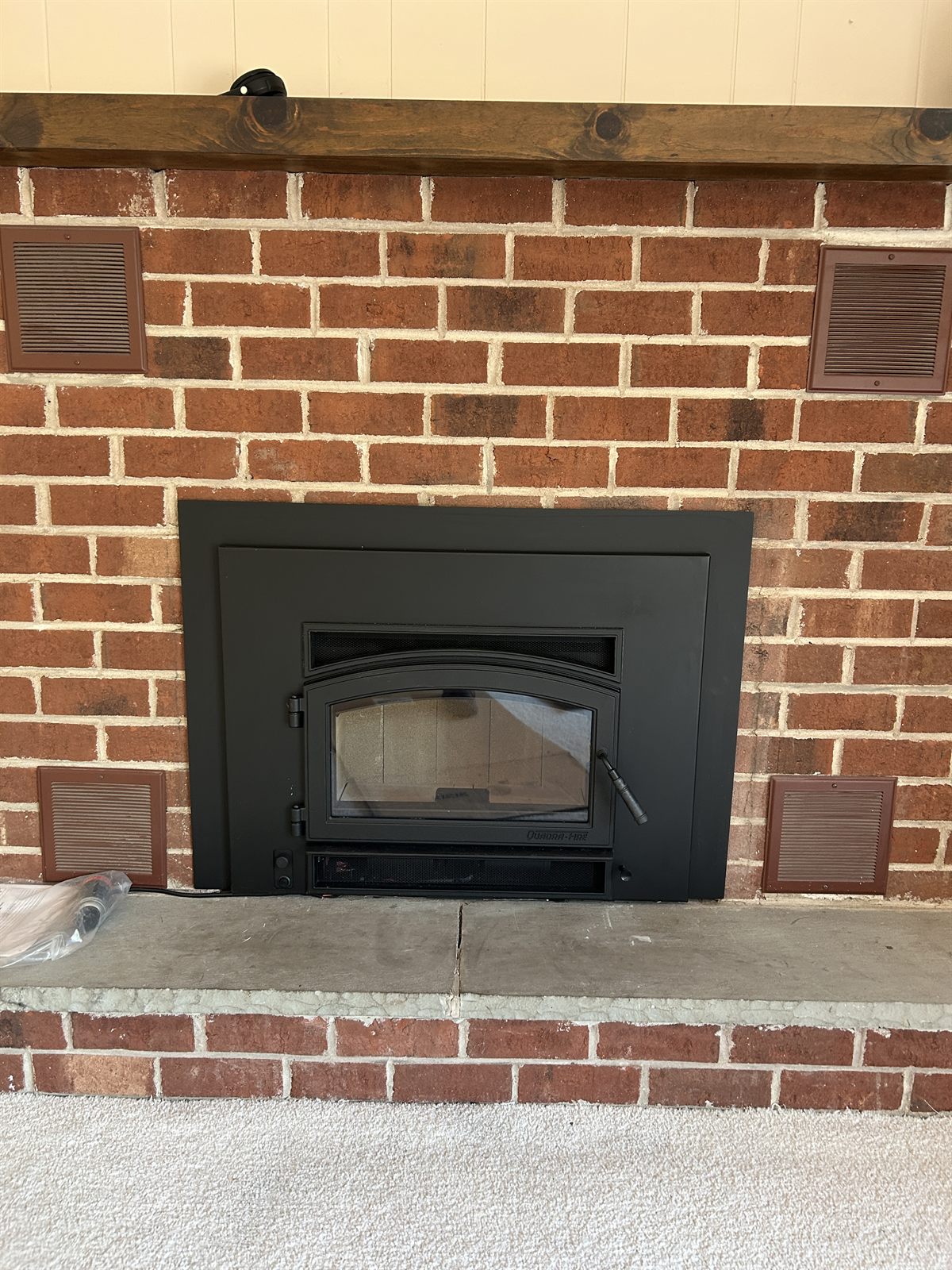 A new wood-burning fireplace insert installed by Hughes